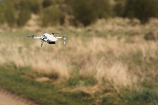 Drone flying in a field background