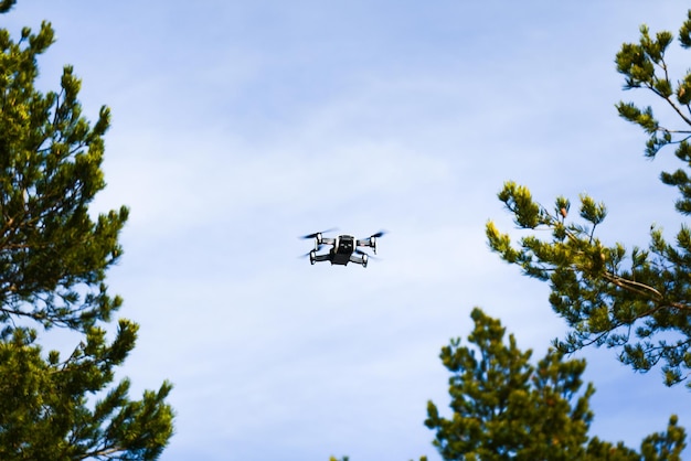 Drone flying overhead in cloudy blue sky in mountains for aerial photography Liptov Slovakia