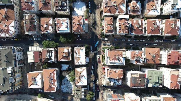 Drone footage of snowy roofs top view of buildings in the city top view of streets and houses