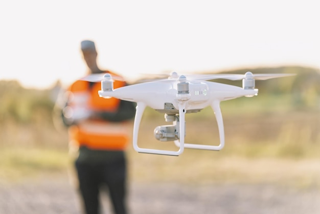 Drone inspection. Operator inspecting construction building site flying with drone