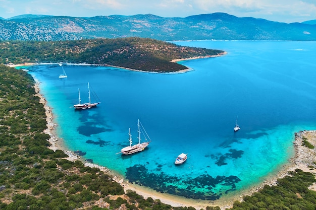 Drone photo aerial view of boats in sea bay among mountain