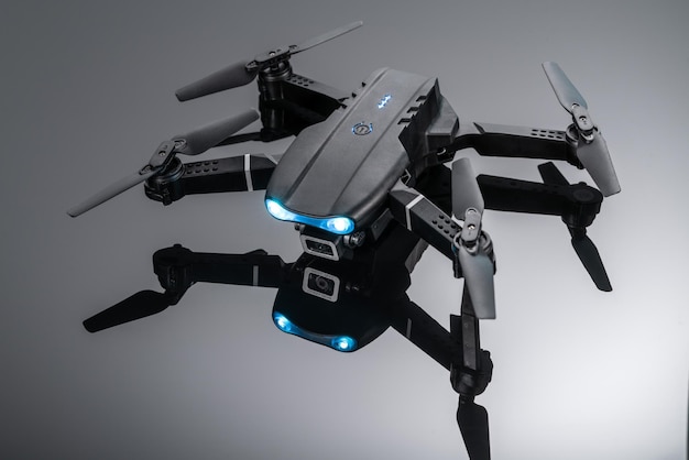 Drone quadcopter with digital camera and sensors on black backgroundBlack quadcopter with a camera