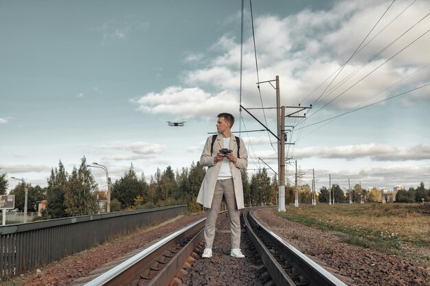 Drone quadrocopter controls off from man hands outdoors