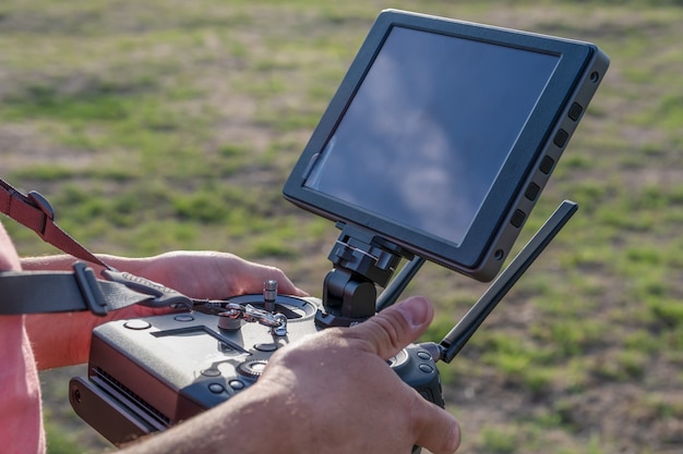 Drone remote control in hand man.Man operating of flying drone