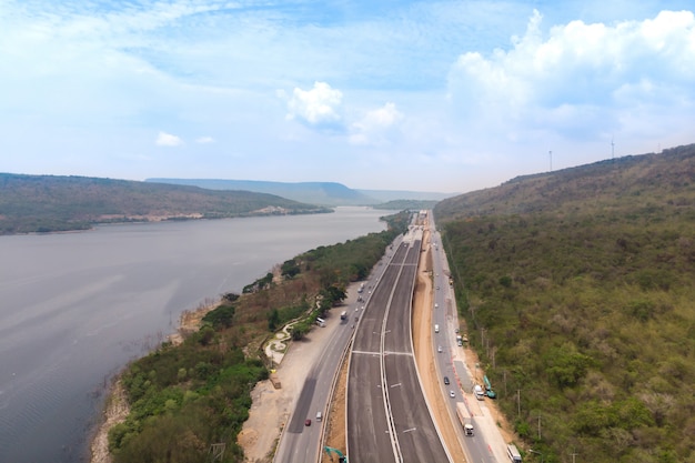 Drone shot aerial view landscape of under construction motorway tolls near big natural river