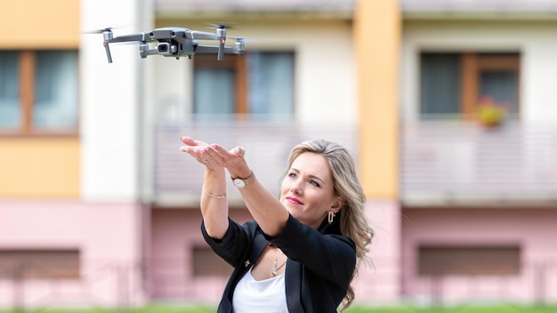 Drone stijgt op uit handen van jonge blonde vrouw moderne technologie concept