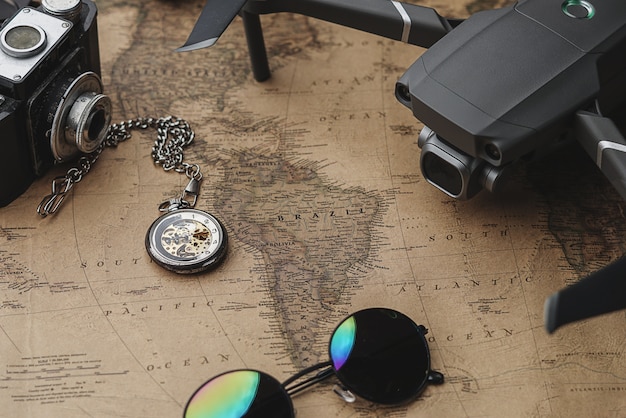 Drone Between Traveler's Accessories on Old Vintage Map