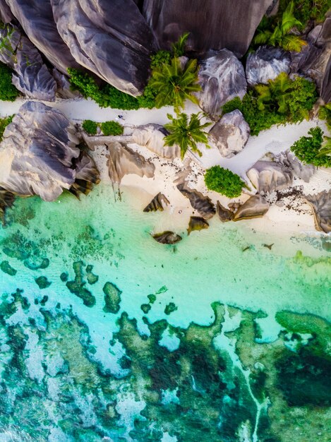 Drone view from above at a tropical beach in the seychelles anse source d39argent la digue