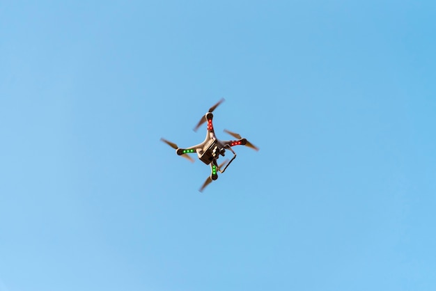 Drone with camera on blue sky