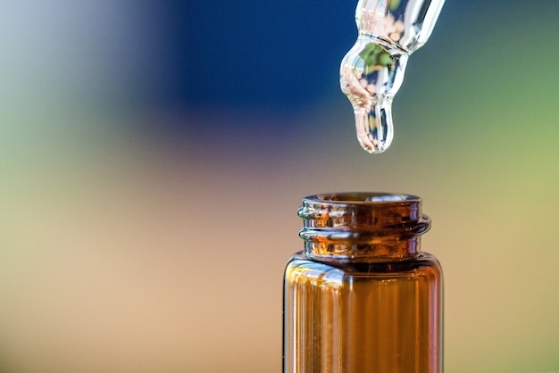 Photo drop drains from the pipette into the bottle neck