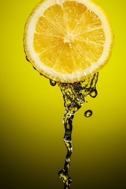 Drop of lemon juice falling down.