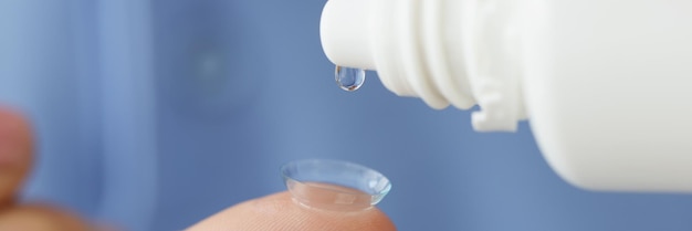 Drop of medical solution on soft contact lens closeup