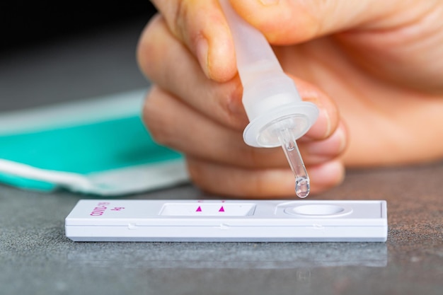 Photo drop nasal sample into rapid antigen test stickpcr rantigen test for check coronavirus