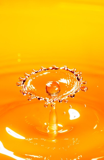 Drop of orange juice close up