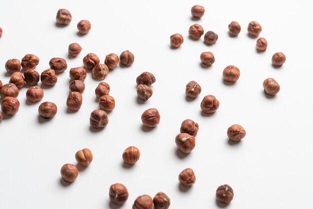 A dropped bunch of hazelnut nut without shell flat lay minimalistic raw food