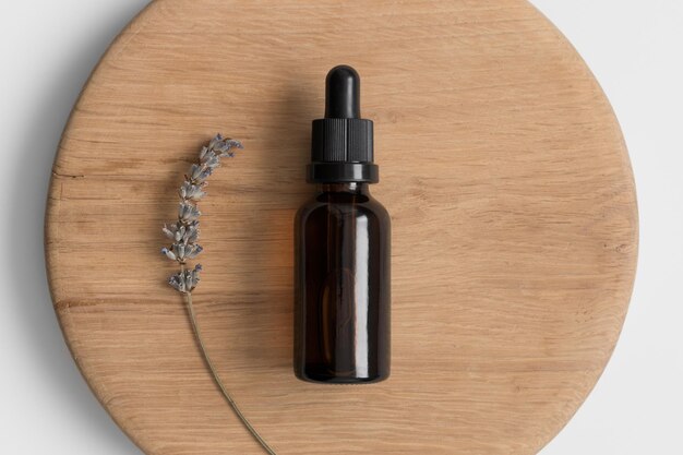 Dropper bottle mockup with lavender on the wooden background