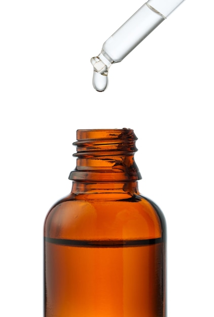 dropper bottle with liquid dropping on a white background