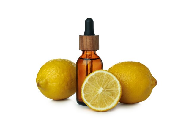 Dropper bottle with oil and lemons isolated on white isolated background