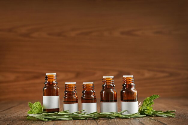 Dropper bottles and herbs on wooden table