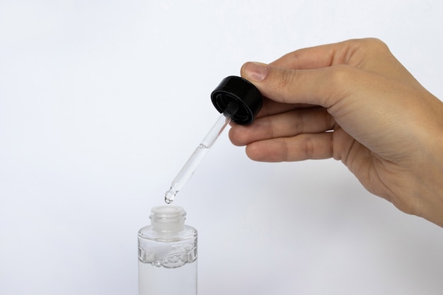 Dropper glass Bottle. Cosmetic pipette on white.