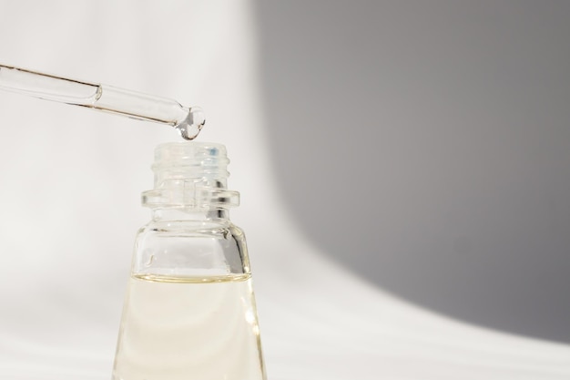 Photo dropper glass bottle mockup cosmetic pipette serum on white background with shdows and hard light