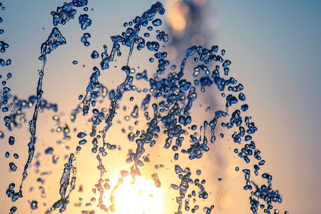 drops of the fountain in the setting sun