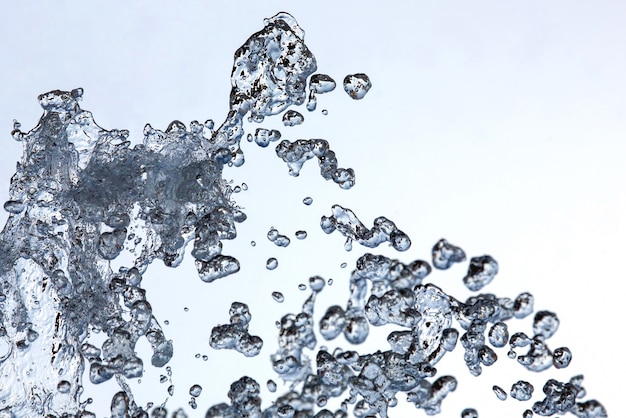 Photo drops of the fountain in the sky. drops of liquid fall close up