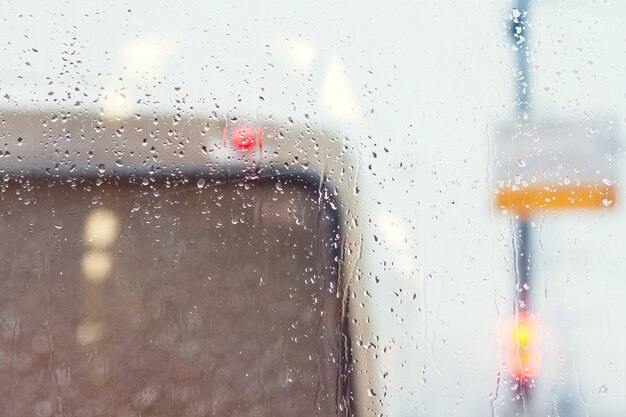 Drops on the glass of the car. Bus ahead