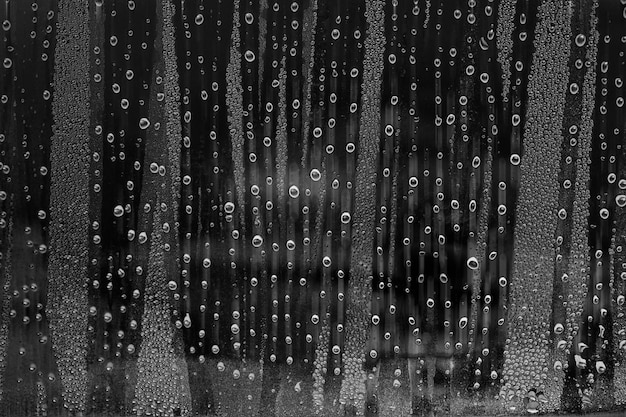 Drops on glass with black and white images.