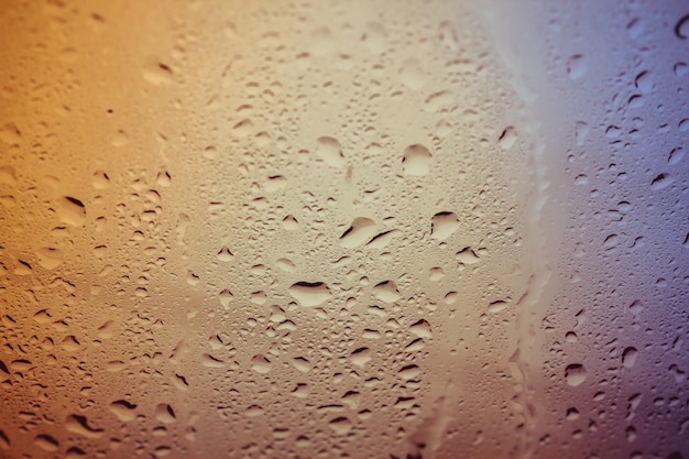 Drops of water on the glass. Background of water drops flowing down the glass. 