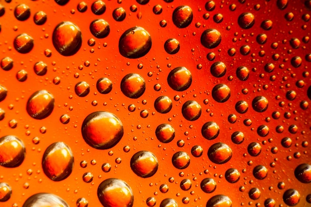 Photo drops of water on pink glass