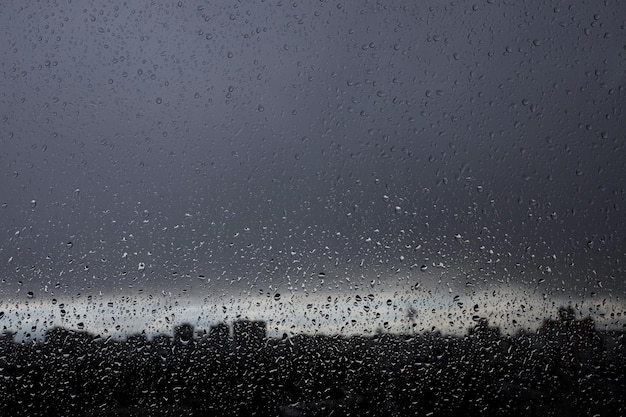 Drops water on wet glass window