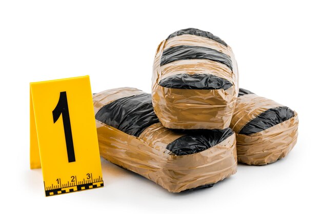 A drug package and a police sign on a white isolated background. The concept of crime.