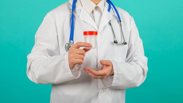 Drug test doctor in blue uniform and medical gloves holding a container for semen analysis donor sperm for artificial insemination infertility treatment planning of children