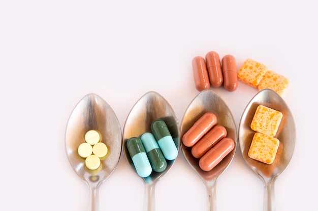 Drugs in spoon,Colorful of oral medications on White Background