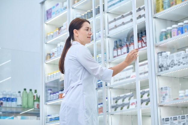 Drugstore. Pharmacist checking medicines in a drugstore