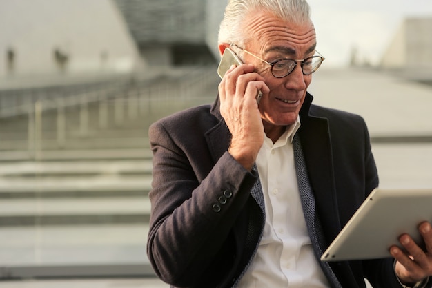 Drukke senior zakenman met een laptop