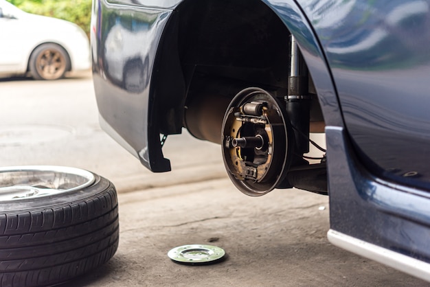 Drum brake and asbestos brake pads at car garage