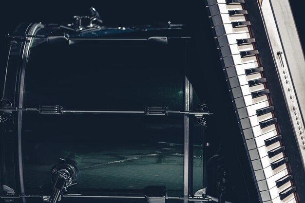 Photo drum and musical keys on a black background close up