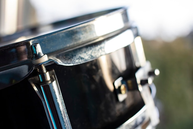 Drum set stands at the window and is lit by the rays of the spring sun and daylight