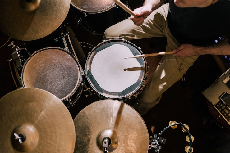 Photo drummer plays on drums top view