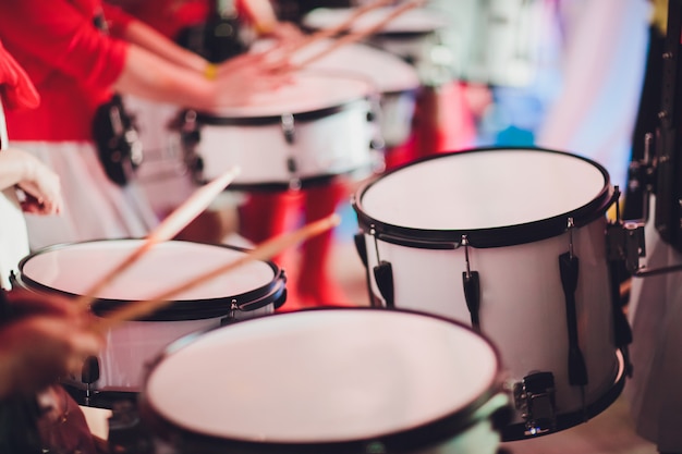 Drummer plays with drumsticks on rock drum set