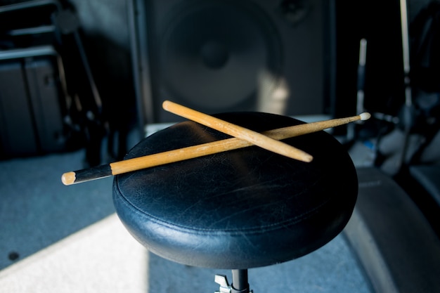 Photo drumstick on chair music background