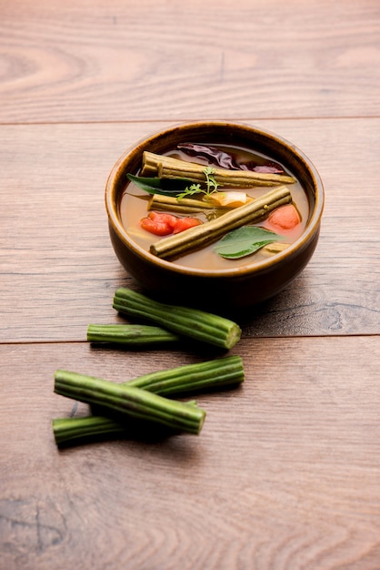 Drumstick Curry or Shevga sheng bhaji or south indian Sambar, served in a bowl over moody background. Selective focus