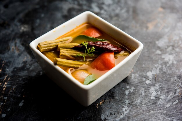 Drumstick Curry or Shevga sheng bhaji or south indian Sambar, served in a bowl over moody background. Selective focus