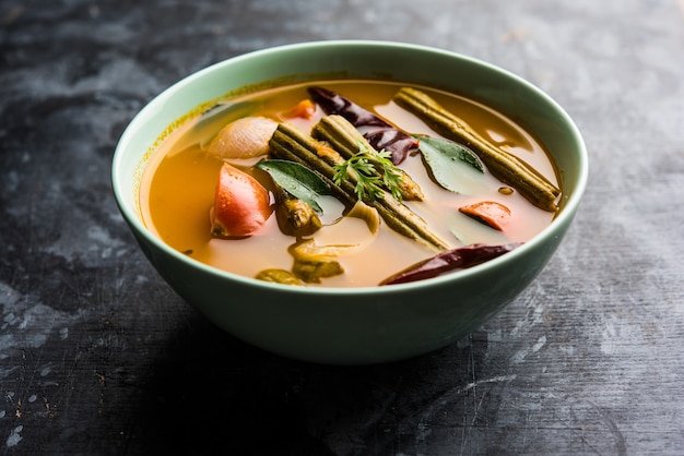 Drumstick Curry or Shevga sheng bhaji or south indian Sambar, served in a bowl over moody background. Selective focus