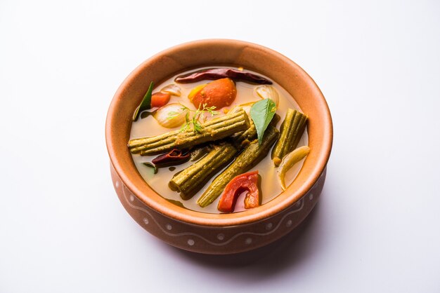 Drumstick Curry or Shevga sheng bhaji or south indian Sambar, served in a bowl over moody background. Selective focus