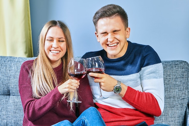 Drunk on the university campus, a young man and woman drink alcohol in a dorm room.