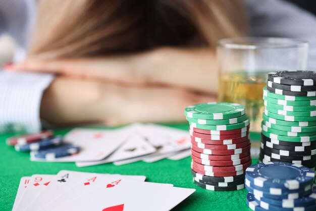 Drunk woman sleeping on gaming table in casino closeup. Gambling addiction concept