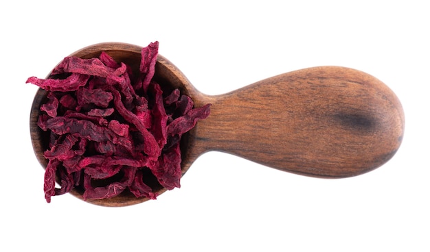 Dry beetroot in wooden spoon isolated on the white background Chopped dried beet Top view